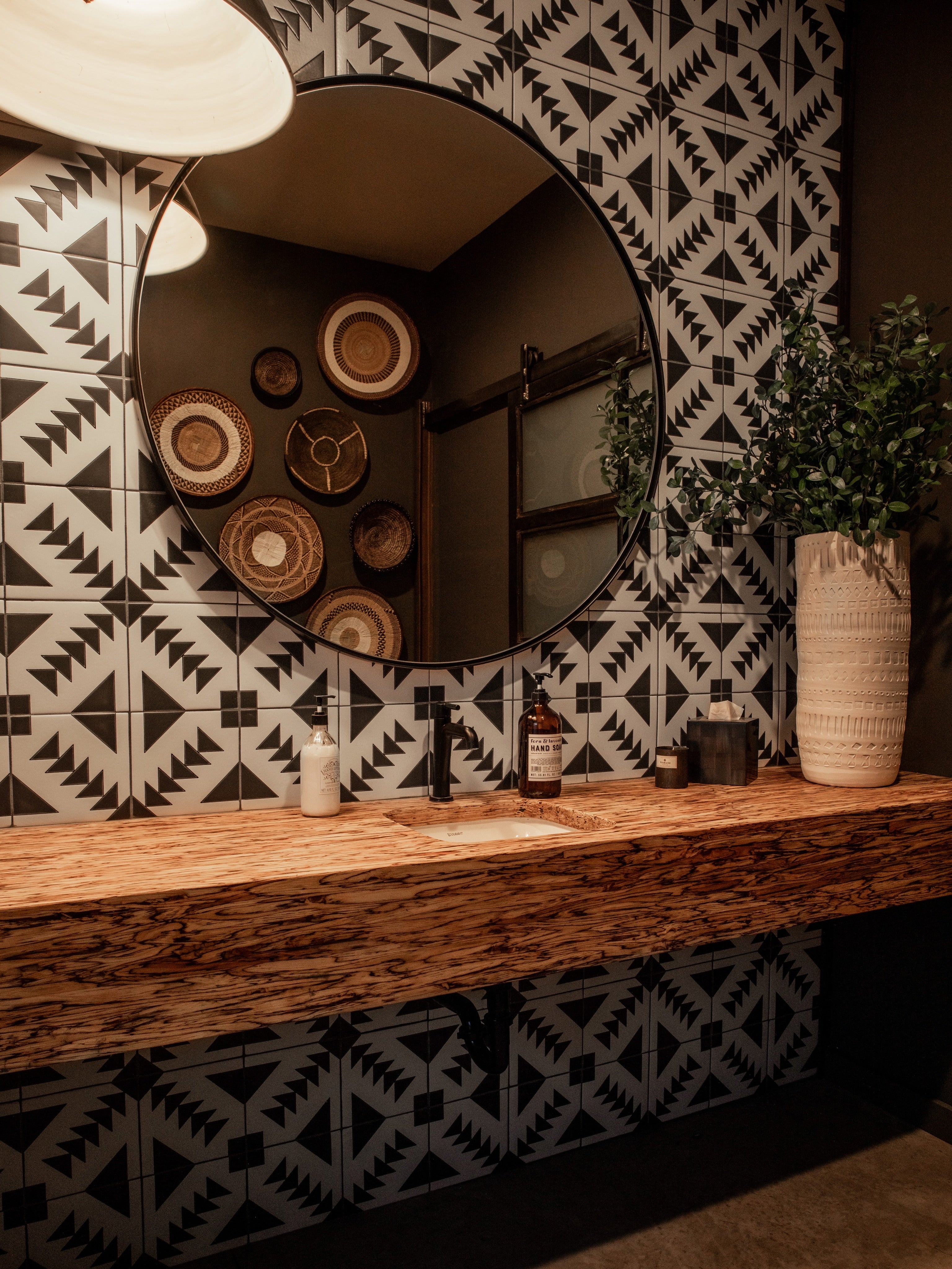 Side view of Black and White Geometric Tile in our T-22 pattern as a full wall bathroom sink backsplash