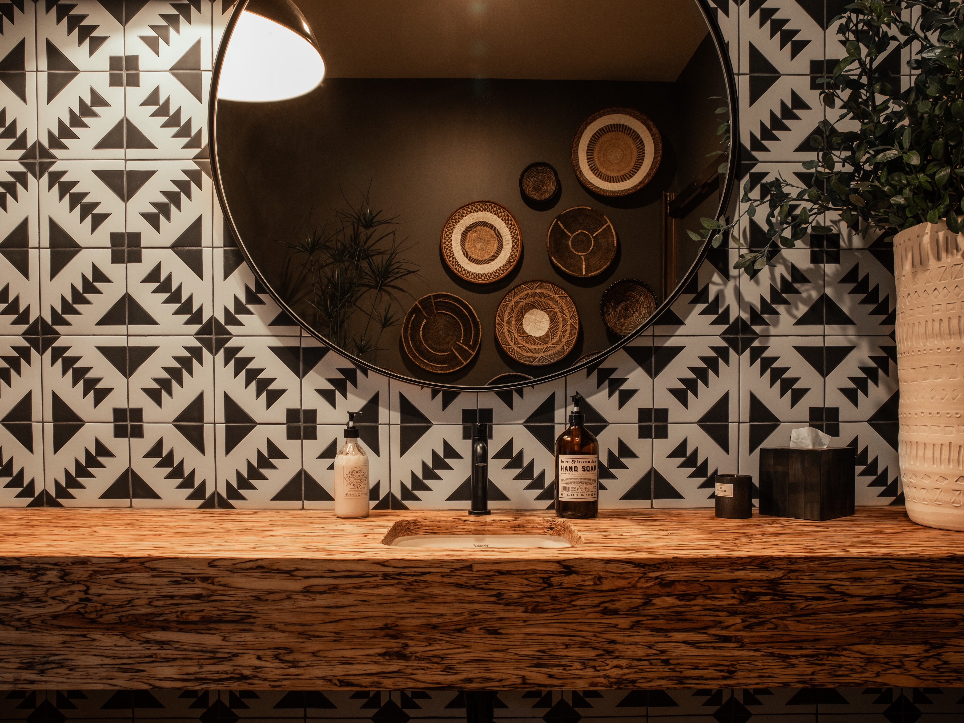 Mid room view of Black and White Geometric Tile in our T-22 pattern as a ranch style bathroom sink backsplash