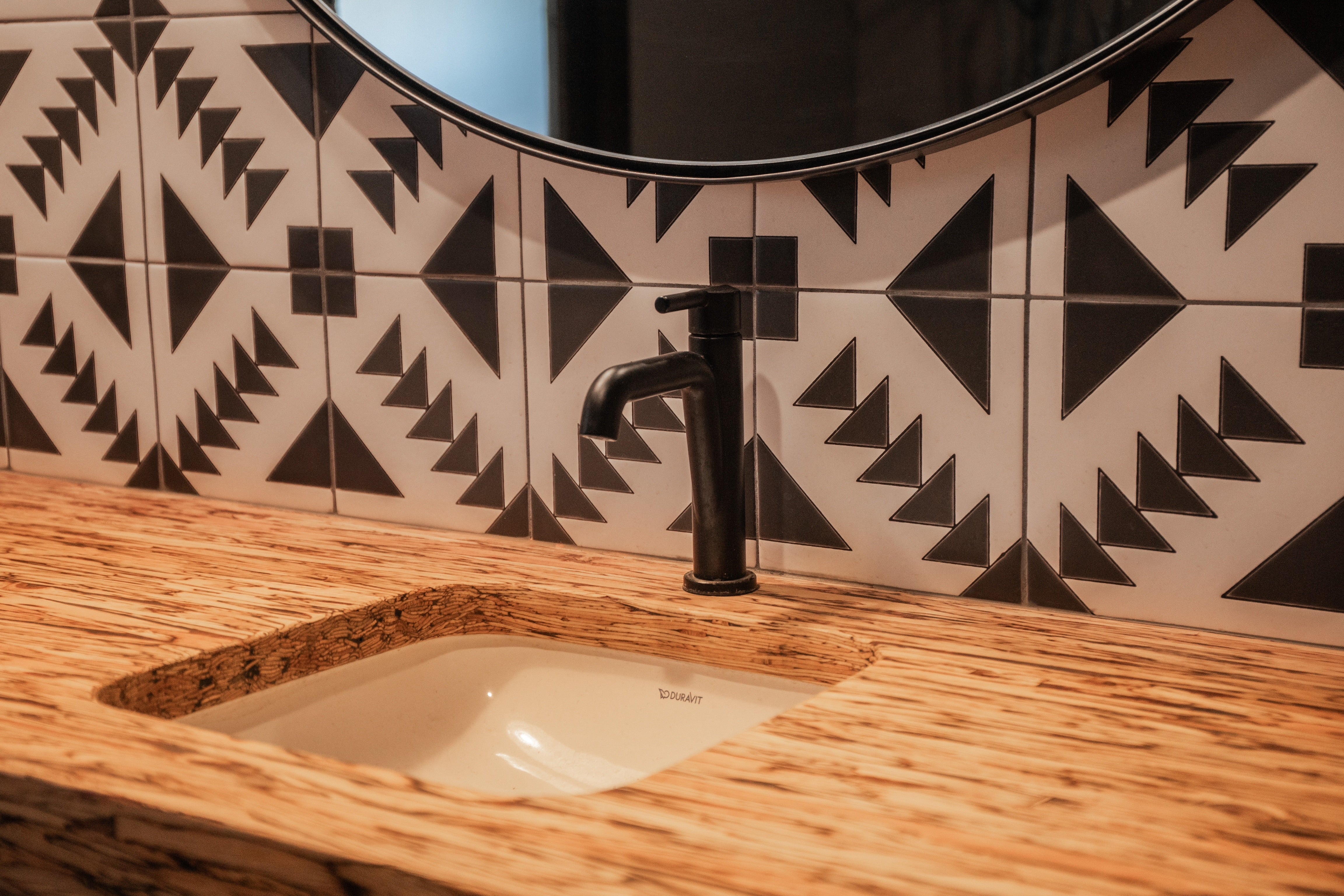 Black and White Geometric Tile in our T-22 pattern as a bathroom sink backsplash