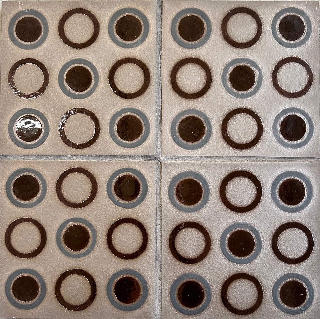 Patterned tiles with circular designs on a beige background