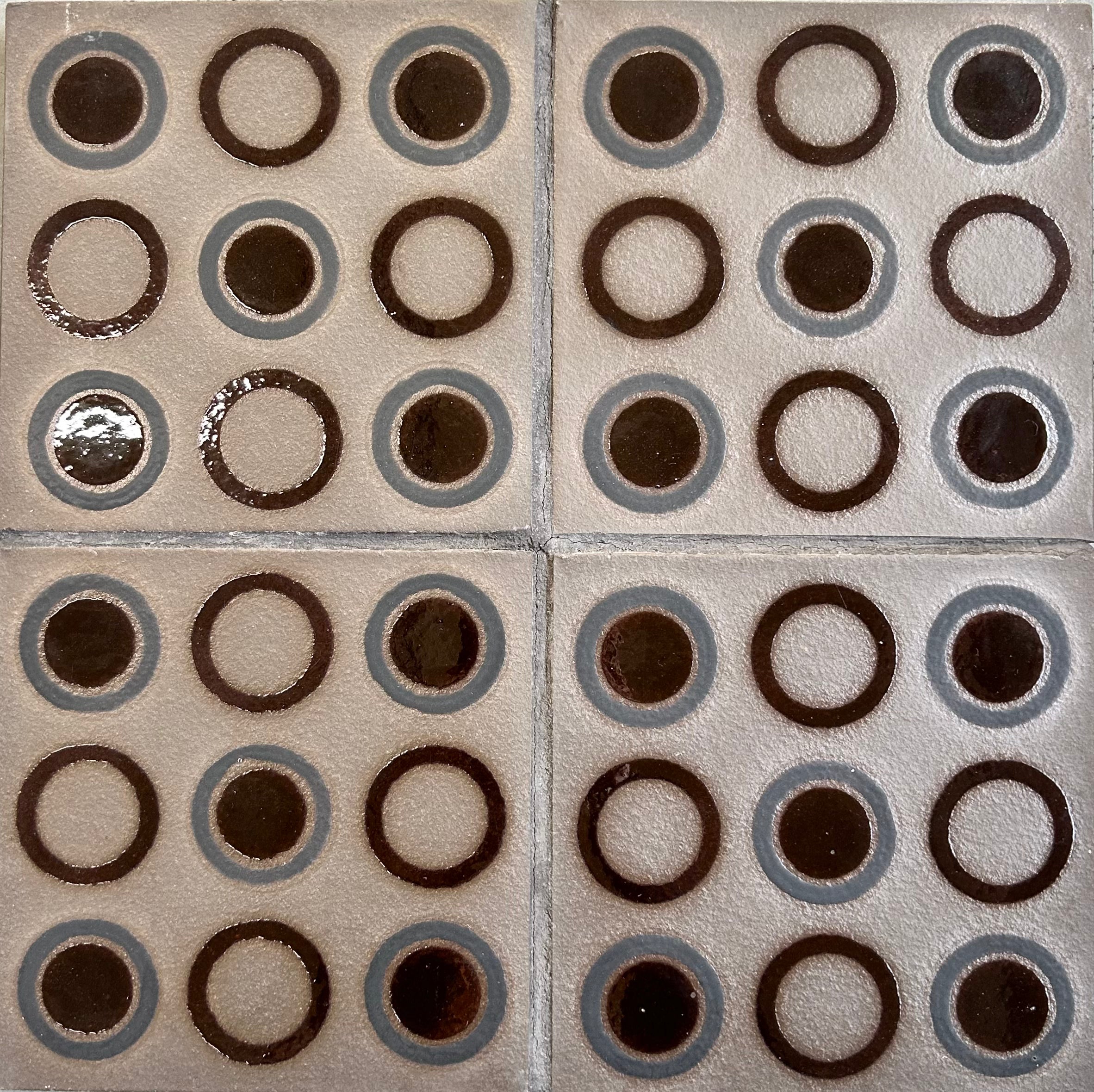 Patterned tiles with circular designs on a beige background