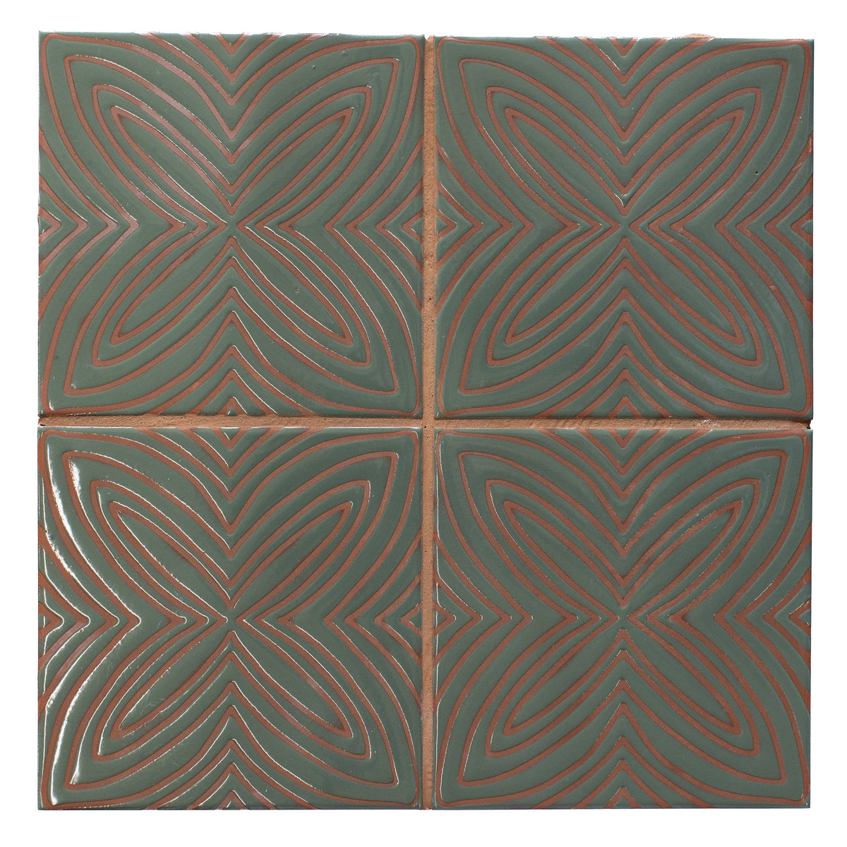 Four green tiles with red geometric patterns arranged in a grid.