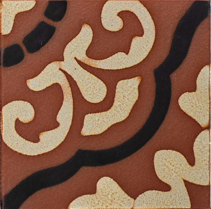 Decorative tile with intricate patterns on a brown background